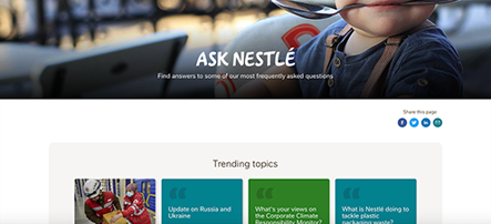 The Ask Nestle site features a visual of a curious toddler with a large spoon in his mouth. A header above article panels reads "trending topics"
